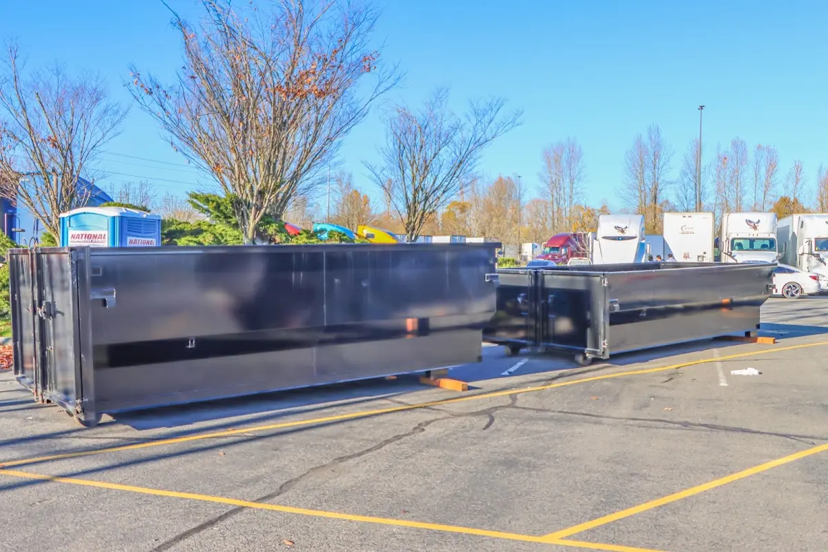 Professional dumpster rental service with roll-off container on residential driveway in Kingman